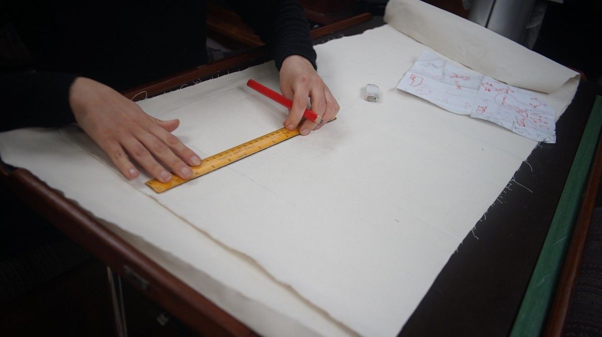 drawing a pattern on fabric someone drawing a pattern on fabric