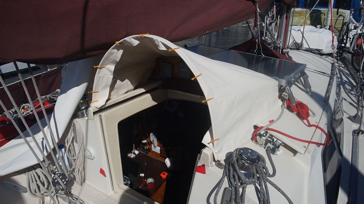 mini dodger fabric fitting a test fit for fabric over a metallic arch on the deck of a sailboat