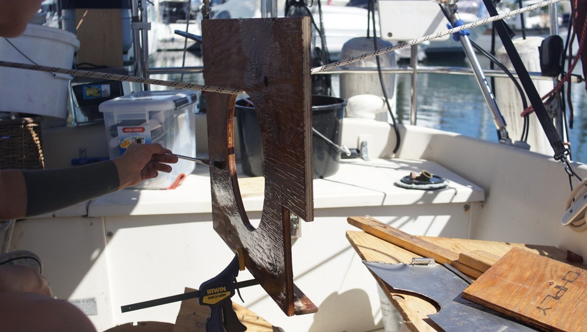 Never epoxy in 34 C weather. Epoxy cures too fast A photo of a piece of wood with someone applying a fresh coat of epoxy