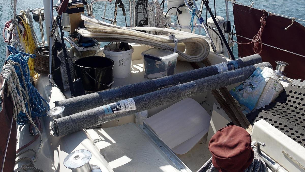 rolls of carpet in a messy, messy cockpit