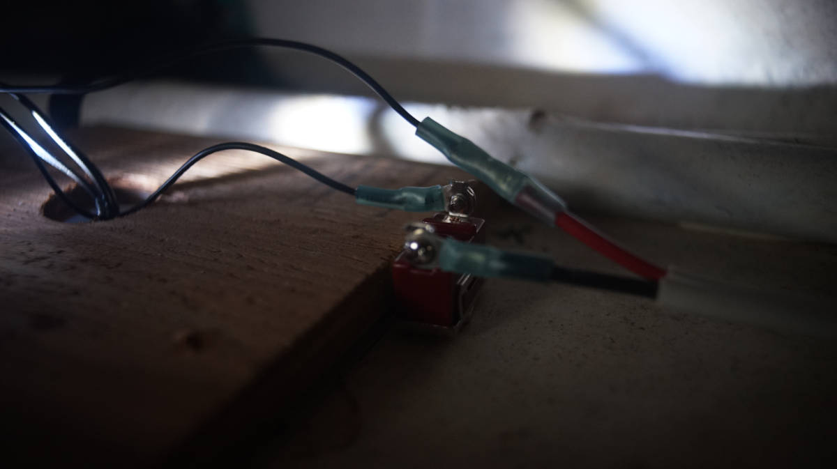 a view inside pinos walls, with wires leading out of a switch and into a light