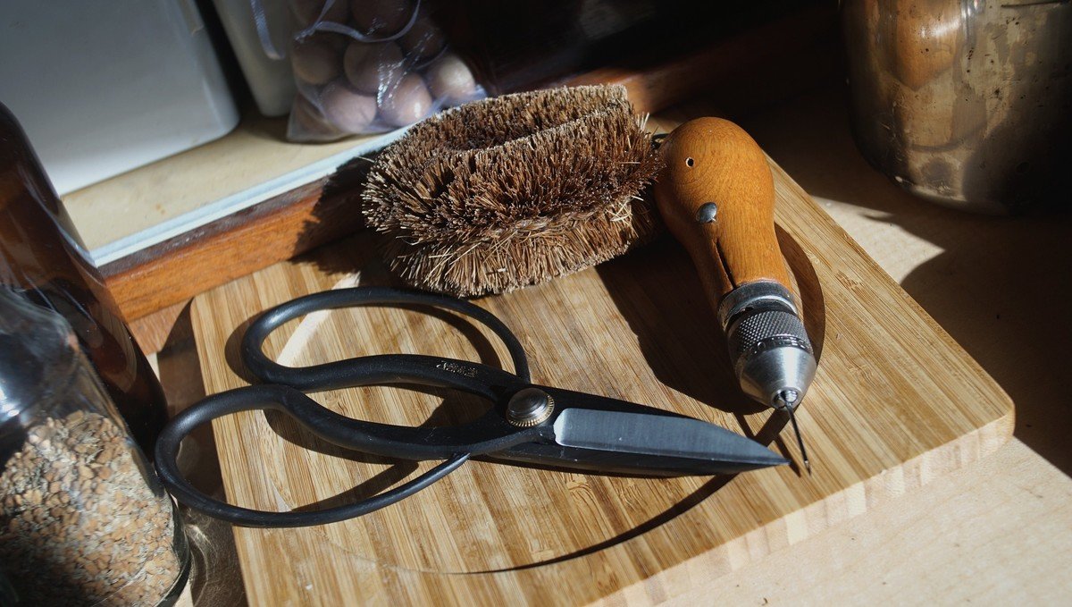 Some of our favorite tools A photo of a tawashi, a sewing awl and a pair of large Japanese-style shears laying on a countertop