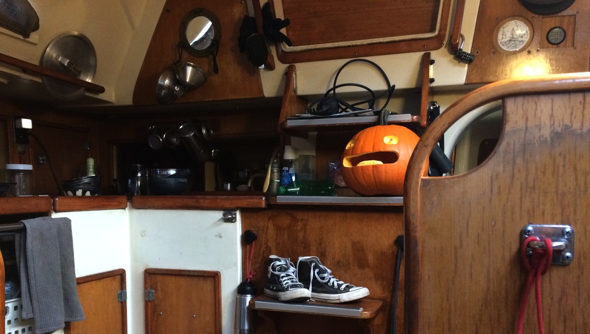 calcifer pumpkin the calcifer pumpkin is on the stairs in the companionway of a sailboat, grinning, having a grand ol time