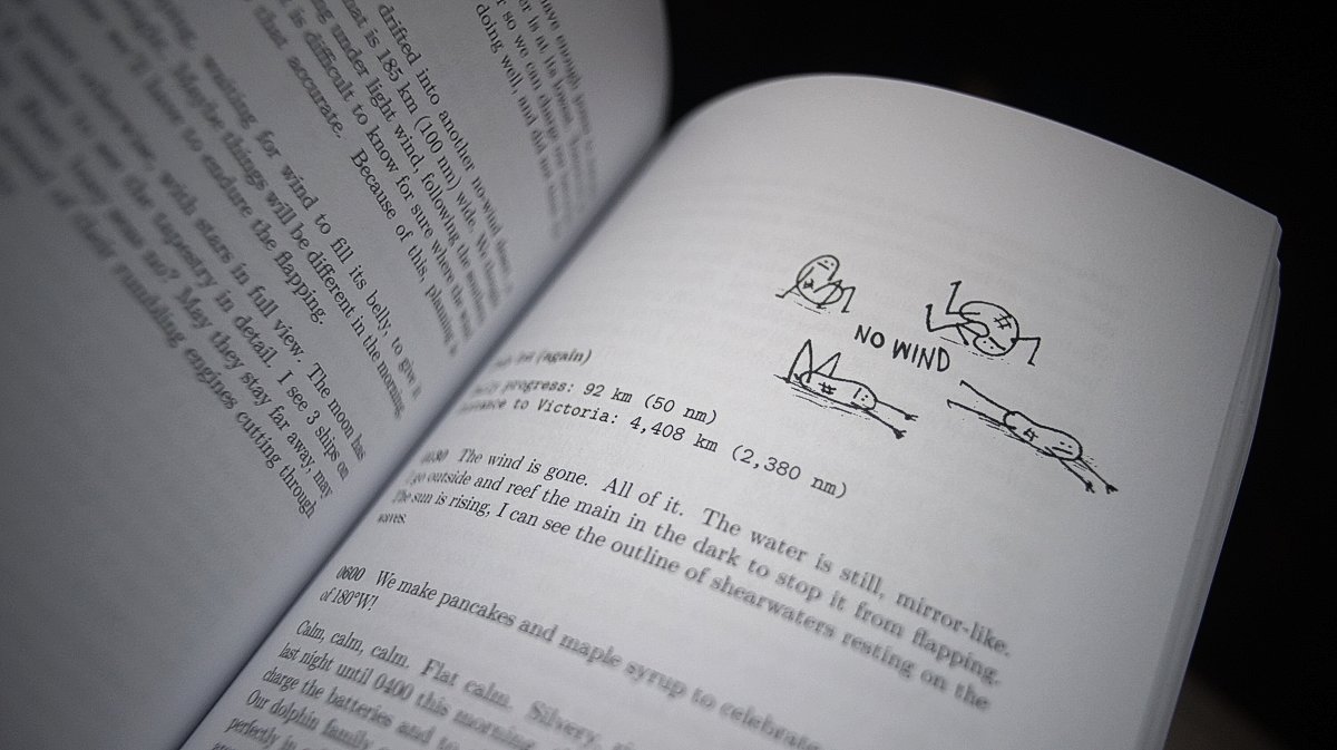A look inside the book A paperback book is opened to a page featuring an illustration of cartoon character waiting for wind