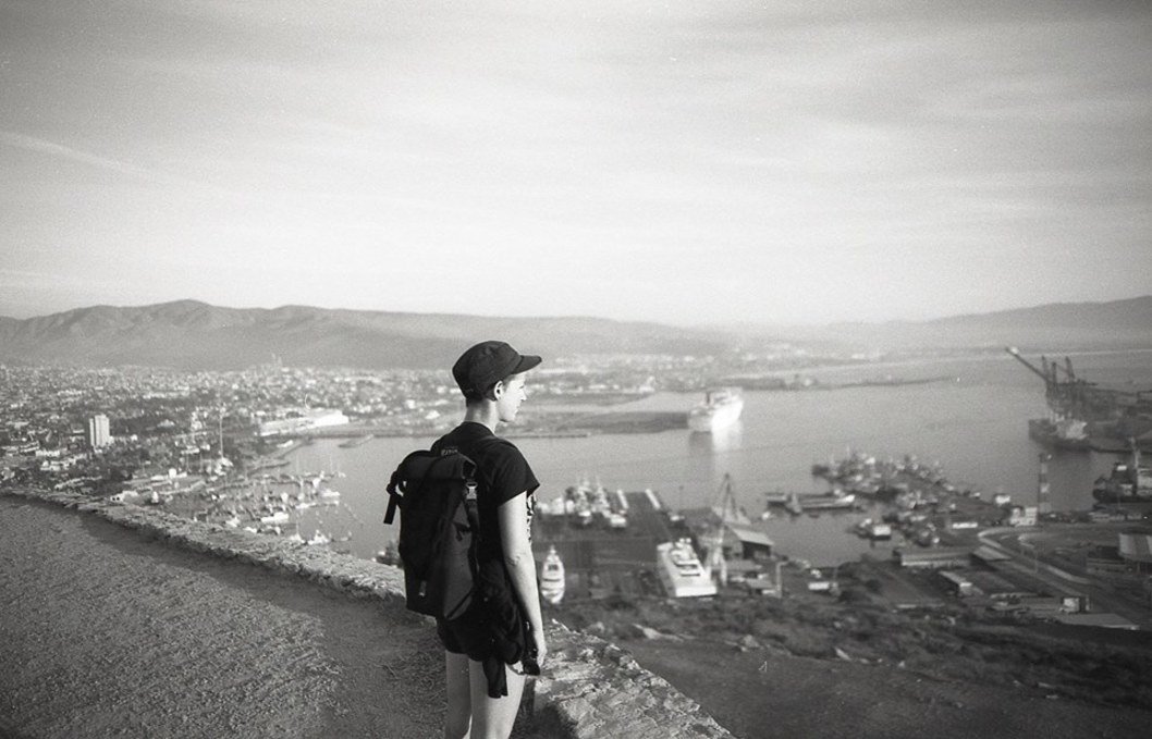 rek standing on a mountain and looking at the port of Ensenada below rek standing on a mountain and looking at the port of Ensenada below