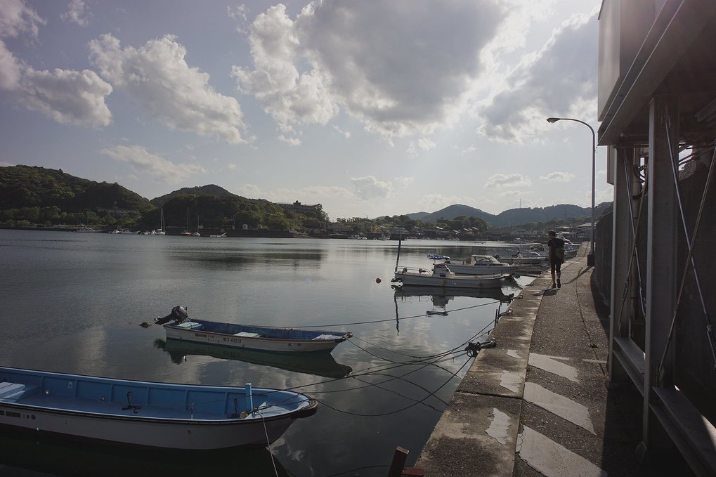Gokasho fishing harbor Devine walking along the Gokasho fishing harbor, with small boats moored onto it