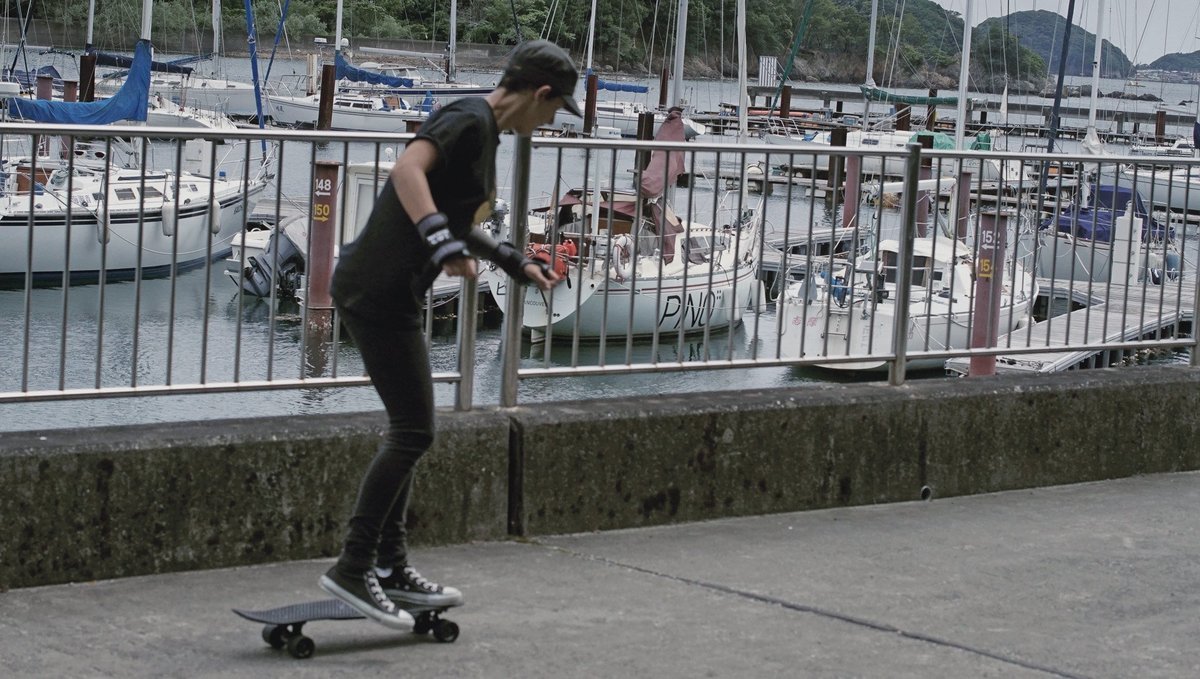 penny board in marina parking lot rek skateboarding in the marina parking lot with Pino moored in the background