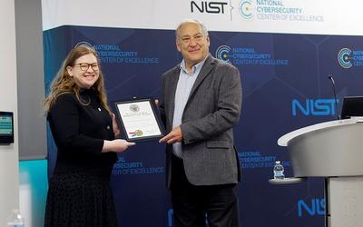 NCCoE Director Cherilyn Pascoe receives Montgomery County certificate from Montgomery County Executive Mr. Marc Elrich