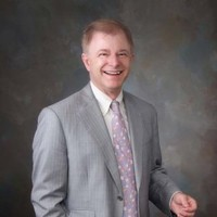 Man in a suit with a gray background