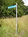Roadsign pointing to the inscription.