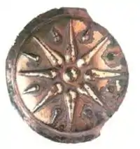 A bronze shield depicting the 16-rayed Vergina Sun