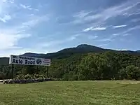 Sign at the bottom of the road, with Mount Washington visible ahead