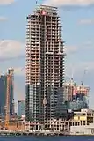 Building under construction in March 2017, viewed from Manhattan.