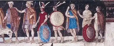 Figures lined up in a row, all with military equipment and dressed colorfully.