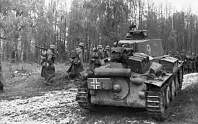 Panzer 38(t) tank with an armored N.K.A.V. mounted below the muffler and painted with a Balkenkreuz.
