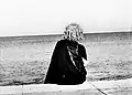Caballero de Paris_sitting on the Malecon sea wall. Havana, Cuba