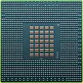 The underside of the 90&nbsp;nm Cell/B.E. processor showing its 1242 solder balls, each 0.6&nbsp;mm in diameter, and its array of 35 capacitors.