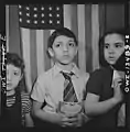 Children waiting in line to buy defense stamps at public school from mothers who volunteer to guard doorways and perform other duties in schools