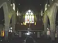 Stained glass windows flanked by the organ pipes