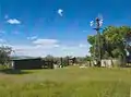 The corral, an outhouse and a windmill attached to the water tank.