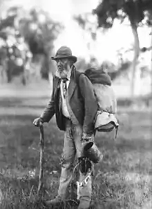 Image 57A swagman in bushman's apparel, wearing a brimmed hat and carrying swag, and billy can. (from Culture of Australia)