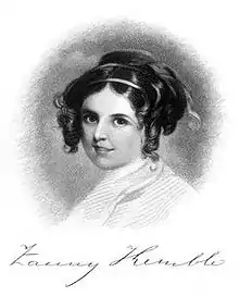 Formal facial portrait photograph of an attractive young woman with ringlets, smiling softly and looking into the camera