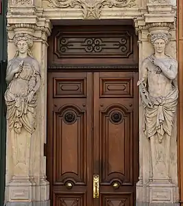 Neoclassical atlas of Mercury and a caryatid of Minerva of Rue Édouard-Herriot no. 39, Lyon, sculpted by Joseph-Hugues Fabisch, 1863