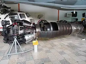 Klimov VK-1F turbojet with afterburner. An afterburner is a propulsive duct in which high velocity exhaust from an engine turbine is converted into pressure in a diffuser. Afterburner fuel is burned with the oxygen in the dilution air which was not involved in the engine combustion process. The gas expands in a nozzle with an increase in velocity. The turbojet afterburner has the same three requirements as a ramjet, both being propulsive ducts. These are conversion of high velocity gas into pressure in a diffuser, combustion and expansion to a higher velocity in a nozzle. As such the turbojet/afterburner combination was sometimes considered in the late 1940s a turbo-ramjet.