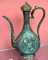 Lidded ewer. Wine pot with floral design; the body decorated with the "Eight Auspicious Symbols" amidst scrolling flowers. Cloisonne enamel on copper. Ming Dynasty, 1550-1600 CE. From China