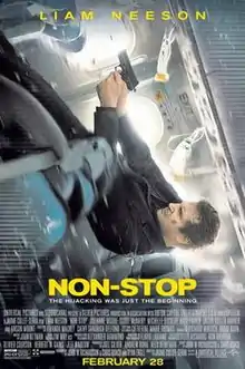 A man falling back along an airplane, firing a gun.