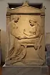 Funerary stele in which appears somebody staying on a klismos, from circa 410–400 BC, in the National Archaeological Museum (Athens, Greece)