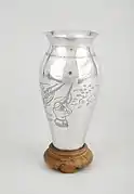 Photograph of a vase made from part of a US plane shot down over Vietnam in 1969 and given to Dr Madeleine Sharp as a representative of the City of Coventry by Nguyễn Thị Bình.
