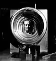 Ronny Jaques: Female worker Barbara Van Dine, of Fredericton, New Brunswick pictured through the breech ring of a QF 4-inch Mk XVI naval gun in the naval inspection department of Sorel Industries, Sorel, Quebec. 1943