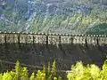 The dam is crowned by the dates 1910–1918 and initials of the managing director Ragnvald Blakstad. The letters are 4&nbsp;m high