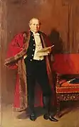 Full length portrait of man wearing dark suit and red fur trimmed robes