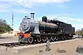 Steam locomotive of South African Railways in front of the station building