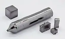Tantalum single crystal, some crystalline fragments, and a 1&nbsp;cm3 tantalum cube for comparison