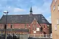 The former Lady Margaret Church, Chatham Street, Southwark, London, built for the St John's College (Cambridge) Mission in 1888–89 by Ewan Christian, now used as the Order of Cherubim and Seraphim Church. Red brick Early English style with typical lancets and apse