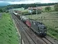 A freight train pulled by 2 Re 420 units
