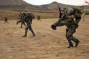 Students simulating moving comrades during a live fire exercise on Camp Pendleton.