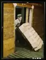 "Loading oranges into refrigerator car at a co-op orange packing plant," March 1943.